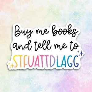 May include: A sticker with a rainbow gradient background and the text "Buy me books and tell me to STFUATTDLAGG" in black.