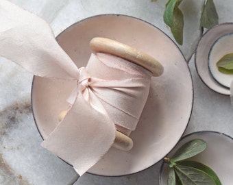 mini styling dish, a single enamelled styling dish in a pale soft almond shade with hand-dyed almond blush silk ribbon