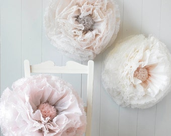 Three giant hand-dyed pompom flowers in dove grey, blush and ivory wedding decor