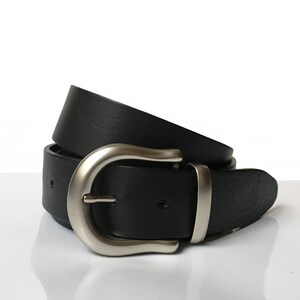 May include: A black leather belt with a silver buckle. The belt is folded in half and the buckle is visible.