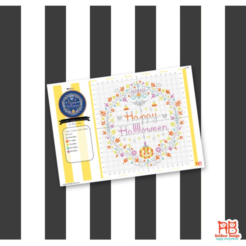 May include: A cross-stitch pattern sheet with a Halloween theme. The design features a wreath with the words "Happy Halloween" in the center, surrounded by pumpkins, bats, and floral elements. The color palette includes orange, purple, and green.