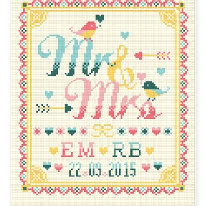 May include: Cross-stitch design with the words "Mrs & Mrs" in teal, yellow, and pink, accented with birds, hearts, and arrows. The design includes the initials "EM RB" and the date "22.09.2015" in a decorative frame.