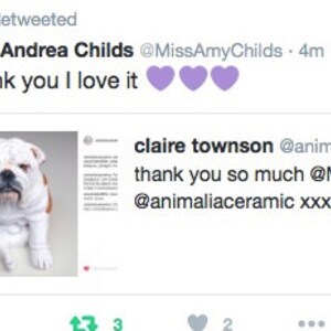 May include: A white bulldog with black spots sits on a white background. The dog is looking at the camera. The text "thank you so much @MissAmyChilds @animaliaceramic xxxx" is visible in the image.