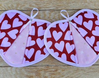 Set of two handmade pink hearts with red background Valentine potholders