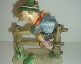 hummel boy on fence with frog