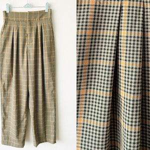 May include: A pair of high-waisted, wide-leg pants in a brown and yellow plaid pattern. The pants have pleats in the front and a straight leg.