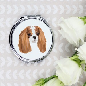 A pocket mirror with a Cavalier King Charles Spaniel dog. A new collection with the geometric dog