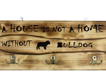 Bulldog, English Bulldog, a wooden wall peg, hanger with the picture of a dog and the words: "A house is not a home without..."