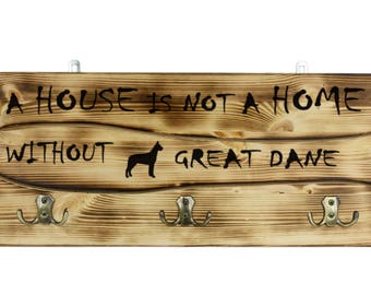 Great Dane, a wooden wall peg, hanger with the picture of a dog and the words: "A house is not a home without..."