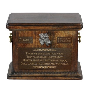 May include: A wooden pet urn with a pewter dog figurine on the lid. The urn is engraved with the name "Charlie" and the dates "*17.07.2005 † 25.02.2018". The urn also has a quote: "Those we love don't go away, they walk beside us everyday, unseen, unheard, but always near, still loved, still missed and very dear."