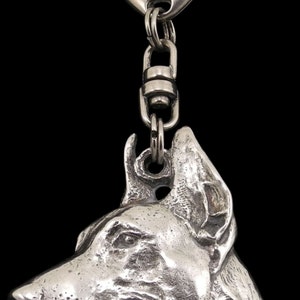 May include: Silver Doberman Pinscher dog keyring. The keyring features a detailed, realistic sculpture of a Doberman's head.