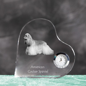 May include: A clear glass heart-shaped clock with an engraved image of an American Cocker Spaniel and the text "American Cocker Spaniel".