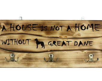 Great Dane, a wooden wall peg, hanger with the picture of a dog and the words: "A house is not a home without..."