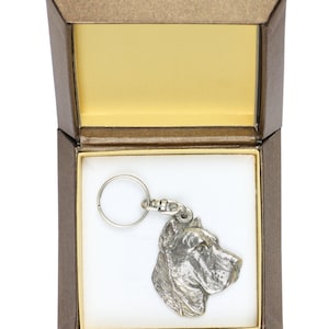 May include: A silver-colored keychain featuring a detailed head of a Cane Corso dog breed. The keychain is displayed in a brown gift box with a white interior.