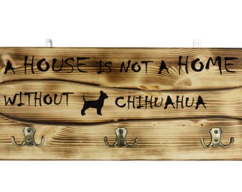 Chihuahua, a wooden wall peg, hanger with the picture of a dog and the words: "A house is not a home without..."