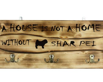 Shar Pei, a wooden wall peg, hanger with the picture of a dog and the words: "A house is not a home without..."