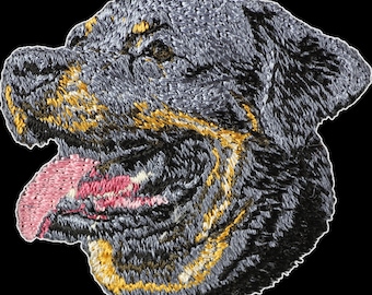 May include: Embroidered patch of a Rottweiler dog's head with a pink tongue sticking out. The dog has black fur with brown markings and a yellow outline.
