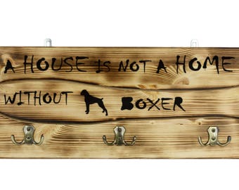 Boxer, a wooden wall peg, hanger with the picture of a dog and the words: "A house is not a home without..."