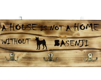 Basenji, a wooden wall peg, hanger with the picture of a dog and the words: "A house is not a home without..."