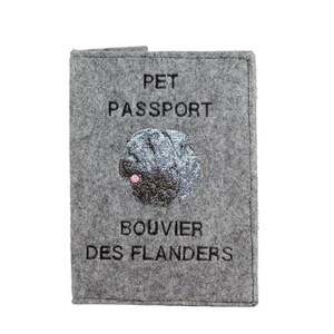 May include: Gray felt pet passport holder with black embroidery that reads "PET PASSPORT" and "BOUVIER DES FLANDERS". A black and white embroidered image of a Bouvier des Flandres dog is in the center.