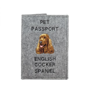May include: Gray felt pet passport cover with embroidered English Cocker Spaniel image. The cover has the words "PET PASSPORT" and "ENGLISH COCKER SPANIEL" in black text.