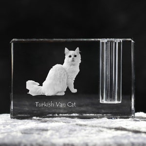 May include: A crystal paperweight with a 3D engraved image of a white Turkish Van cat. The paperweight has a clear glass tube on the side. The text "Turkish Van Cat" is engraved below the image.