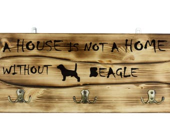 Beagle, a wooden wall peg, hanger with the picture of a dog and the words: "A house is not a home without..."