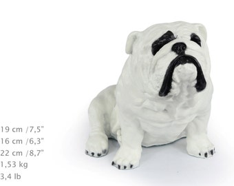 Könnte beinhalten: Eine weiße Bulldoggen-Figur mit schwarzen Markierungen um Augen, Nase und Mund. Die Figur misst 19 cm in der Höhe, 16 cm in der Breite, 22 cm in der Tiefe und wiegt 1,53 kg, wie durch den aufgedruckten Text angegeben.