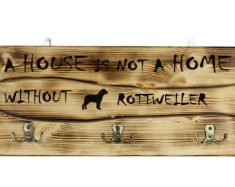 Rottweiler, a wooden wall peg, hanger with the picture of a dog and the words: "A house is not a home without..."