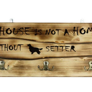 Setter, a wooden wall peg, hanger with the picture of a dog and the words: &quot;A house is not a home without...&quot;