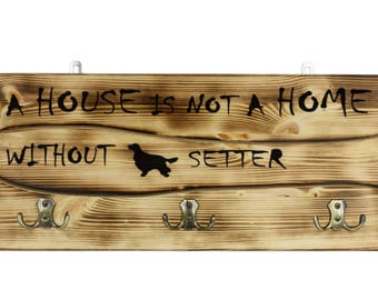 Setter, a wooden wall peg, hanger with the picture of a dog and the words: "A house is not a home without..."