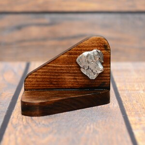 May include: A wooden dog-shaped business card holder with a silver metal dog head on the front. The holder is dark brown and has a rustic finish.