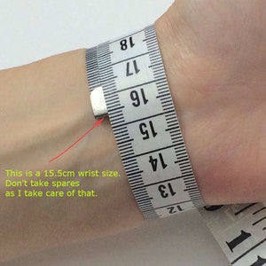 May include: A white measuring tape wrapped around a wrist, showing a measurement of 15.5 cm. The text "This is a 15.5cm wrist size. Don't take spares as I take care of that." is written below the image.