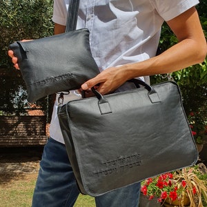 May include: A black leather briefcase with a zippered pouch. Both bags have Hebrew text embossed on them.