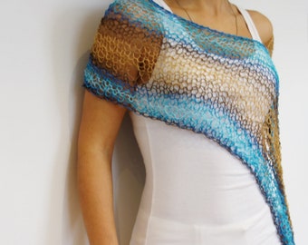 May include: A blue, brown, and beige crocheted shawl with a diagonal pattern. The shawl is draped over the shoulders of a person wearing a white tank top and white pants.