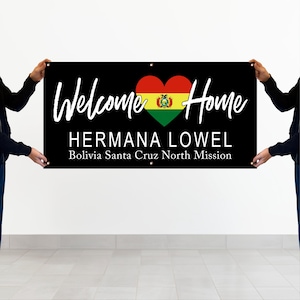 Two people holding a banner that says "Welcome Home HERMANA LOWEL Bolivia Santa Cruz North Mission"