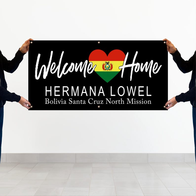 Two people holding a banner that says "Welcome Home HERMANA LOWEL Bolivia Santa Cruz North Mission"