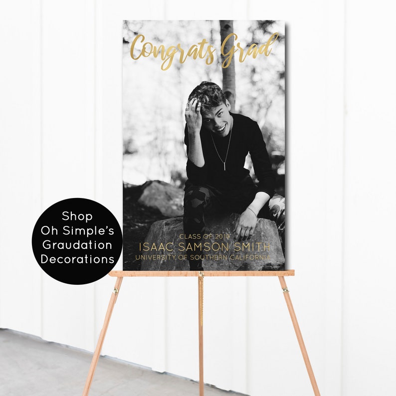 May include: Black and white photo of a graduate in a cap and gown, with the text "Congrats Grad" in gold lettering. The text "Class of 2018" and "Isaac Samson Smith" is also in gold lettering. The text "University of Southern California" is in black lettering.