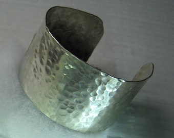 Wide, sterling silver cuff bracelet.