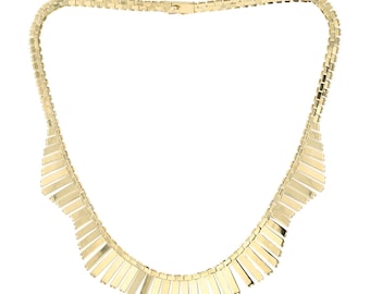 May include: A gold necklace with a graduated, fringe-like design. The necklace is made of linked, rectangular pieces that get progressively longer towards the bottom.