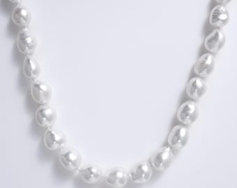 May include: A necklace composed of a single strand of white, irregularly shaped baroque pearls. Each pearl features a high-luster, reflective surface with unique organic contours, strung together to form a continuous, elegant circular arrangement.