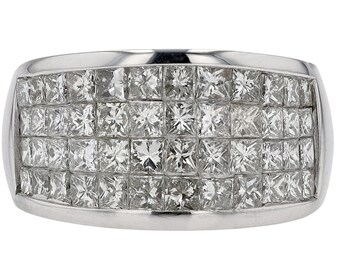 May include: A wide, rectangular ring with a silver band. The ring's surface is covered with multiple rows of square-cut, clear gemstones, creating a sparkling, textured effect. The gemstones are set closely together.