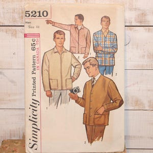 May include: Vintage Simplicity pattern 5210 for men's jackets and shirts. The illustration shows various jacket styles in tan, pink, and blue plaid. The pattern includes a size 44. The text on the pattern reads "Printed Pattern 65c in Canada 75c".