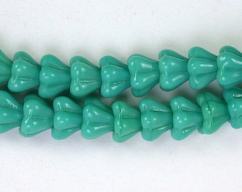 Turquoise opaque 4 x 6mm tiny trumpet flower bead, drilled down middle. Set of 50.
