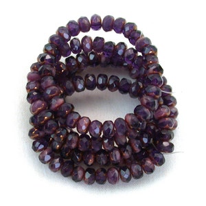 Purple transparent Purple opaque blend with Bronze smaller 3 x 5mm rondelles. Set of 30 or 60.