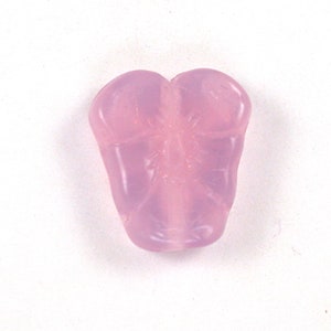 May include: A light pink glass bead shaped like a butterfly with a detailed design.