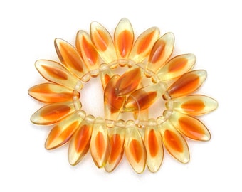 Ljus urangul gyllenbrun UV-aktiv transparent dolkar i större storlek 17 x 7 mm. Set om 25.