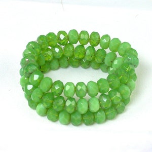 Yellow Green opaline w/ picasso 6 x 9mm rondelles. Set of 25.