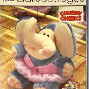 May include: Simplicity pattern 7417 for a stuffed elephant toy. The elephant is gray and beige, wearing a pink tutu and a rose. The pattern is from 1984 and is labeled "Chubby Cheeks".