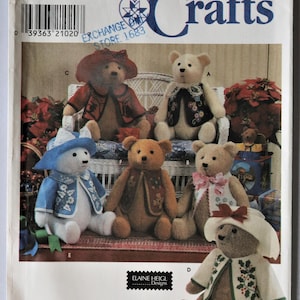 May include: A Simplicity Crafts sewing pattern envelope 7895 for stuffed teddy bears. The cover displays six bears wearing various outfits including hats, vests, and jackets with floral and holiday-themed patterns. The text includes 7895, ONE SIZE, Simplicity, Crafts, and ELAINE HEIGL Designs.